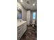 Bathroom with wood-look flooring, storage, vanity, and natural light at 11304 Altoona Ave, New Port Richey, FL 34654
