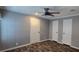 Bedroom featuring wood-look flooring, closet, ceiling fan, and ample natural light at 11304 Altoona Ave, New Port Richey, FL 34654