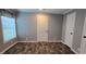 Neutral bedroom features a large window and luxury vinyl plank flooring at 11304 Altoona Ave, New Port Richey, FL 34654