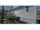 A manufactured home's exterior with a gray AC unit and a wooden staircase to the back entrance at 11304 Altoona Ave, New Port Richey, FL 34654