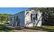 Inviting white home features black shutters, and a stairway leading to the front door at 11304 Altoona Ave, New Port Richey, FL 34654