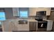 Bright, renovated kitchen featuring stainless steel appliances and ample counter space at 11304 Altoona Ave, New Port Richey, FL 34654