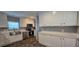 Modern kitchen features white cabinets, stainless steel appliances, and a stylish sink at 11304 Altoona Ave, New Port Richey, FL 34654