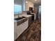 Modern kitchen features stainless steel appliances, farmhouse sink, and white cabinets at 11304 Altoona Ave, New Port Richey, FL 34654