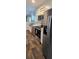 Modern kitchen with stainless steel appliances, farmhouse sink, and wood-look flooring at 11304 Altoona Ave, New Port Richey, FL 34654