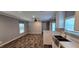 Open living room with wood-look flooring, ample natural light, and ceiling fan at 11304 Altoona Ave, New Port Richey, FL 34654