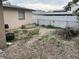 The backyard features a fence line, a grill, a fire pit, and plenty of space at 11515 Meredith Ln, Port Richey, FL 34668