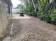The backyard features a brick paver patio, a round patio table, and gravel throughout at 11515 Meredith Ln, Port Richey, FL 34668