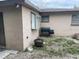 The backyard features a grill, a fire pit, a window, and sliding glass doors at 11515 Meredith Ln, Port Richey, FL 34668