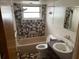 Bathroom with tiled walls, a bathtub and shower combo, toilet, and vanity sink at 11515 Meredith Ln, Port Richey, FL 34668