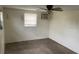 Bedroom showcasing a ceiling fan and light fixture along with carpeted floors at 11515 Meredith Ln, Port Richey, FL 34668