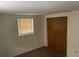 This bedroom offers neutral walls, carpet flooring, a window, and a closet at 11515 Meredith Ln, Port Richey, FL 34668