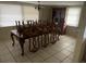 Dining room features a table with chairs, a chandelier and a display cabinet at 11515 Meredith Ln, Port Richey, FL 34668