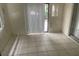 Enclosed patio area featuring tile floors, a window, and sliding glass door at 11515 Meredith Ln, Port Richey, FL 34668