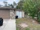 Exterior shot of a home with a stone facade and grassy front yard at 11515 Meredith Ln, Port Richey, FL 34668