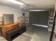 Garage features an open garage door, shelving, and furniture at 11515 Meredith Ln, Port Richey, FL 34668
