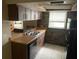This kitchen has a stainless steel sink, wooden cabinets, and a black refrigerator at 11515 Meredith Ln, Port Richey, FL 34668