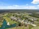 Expansive aerial view of a residential community with golf courses, ponds, and lush green spaces at 11631 Wayside Willow Ct, Hudson, FL 34667