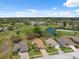 Aerial view showcasing the property's location on a golf course and a nearby lake, offering scenic beauty at 11631 Wayside Willow Ct, Hudson, FL 34667