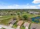 Aerial view featuring the home's location with a golf course and lake nearby in the community at 11631 Wayside Willow Ct, Hudson, FL 34667