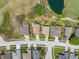 Birds-eye view of homes in a golf course community featuring lush greenery, a pond, and well-maintained landscaping at 11631 Wayside Willow Ct, Hudson, FL 34667