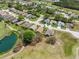 Areal view of residential neighborhood with golf course, pond, and lush landscaping at 11631 Wayside Willow Ct, Hudson, FL 34667