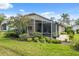 Beautiful backyard featuring a screened lanai, lush landscaping, and a serene outdoor space at 11631 Wayside Willow Ct, Hudson, FL 34667