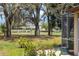 Backyard view overlooking a golf course, mature trees, and lush landscaping, offering scenic vistas at 11631 Wayside Willow Ct, Hudson, FL 34667