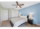 Bright bedroom featuring a ceiling fan, a blue accent wall and neutral decor at 11631 Wayside Willow Ct, Hudson, FL 34667