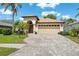 Charming single-story home with lush landscaping, paver driveway, and a two-car garage at 11631 Wayside Willow Ct, Hudson, FL 34667