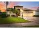 Charming single-story home with lush landscaping, paver driveway, and a two-car garage at sunset at 11631 Wayside Willow Ct, Hudson, FL 34667