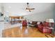 The living room and kitchen combine to make an open floor plan layout with hardwood and tile flooring, respectively at 11631 Wayside Willow Ct, Hudson, FL 34667