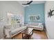 Bright living room with hardwood floors, two sofas, large windows and serene views of the lush landscaping at 11631 Wayside Willow Ct, Hudson, FL 34667