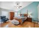 Comfortable main bedroom with a four-poster bed, hardwood floors, and ample natural light at 11631 Wayside Willow Ct, Hudson, FL 34667