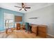 Spacious office with hardwood floors, a ceiling fan and a window with natural light at 11631 Wayside Willow Ct, Hudson, FL 34667