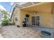 Screened in patio with ceiling fan, outdoor grill and view of the backyard at 11631 Wayside Willow Ct, Hudson, FL 34667