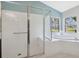 Bathroom shower featuring a glass door, seating, and a garden tub at 11631 Wayside Willow Ct, Hudson, FL 34667