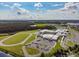 Aerial view showcases a sprawling community hospital with ample parking, surrounded by green spaces, lakes, and a serene environment at 12272 Rangeland Blvd, Odessa, FL 33556