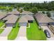 Aerial view of homes with manicured lawns and a serene lake backdrop at 12272 Rangeland Blvd, Odessa, FL 33556