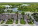 An aerial view of the neighborhood with a lake and green foliage in the background at 12272 Rangeland Blvd, Odessa, FL 33556