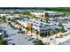 Aerial view of retail shops with ample parking surrounded by palm trees and community at 12272 Rangeland Blvd, Odessa, FL 33556