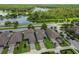An aerial view of the neighborhood with a lake and green foliage in the background at 12272 Rangeland Blvd, Odessa, FL 33556