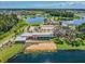 Aerial view of a modern community center surrounded by lakes and green spaces at 12272 Rangeland Blvd, Odessa, FL 33556