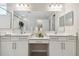 Elegant bathroom featuring double sinks, granite countertops, and a large mirror, offering a stylish and functional space at 12272 Rangeland Blvd, Odessa, FL 33556