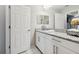 Bathroom featuring granite countertops, white cabinets, and a mirror at 12272 Rangeland Blvd, Odessa, FL 33556