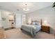 Comfortable bedroom featuring carpet, a plush bed with patterned bedding and a doorway at 12272 Rangeland Blvd, Odessa, FL 33556