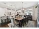 Open-concept dining room featuring a large wooden table, stylish chairs, and views of the modern kitchen at 12272 Rangeland Blvd, Odessa, FL 33556