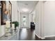 Bright and airy foyer with hardwood floors, leading to a living space with stylish furnishings and decor at 12272 Rangeland Blvd, Odessa, FL 33556