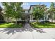 Charming two-story home with landscaped yard and a cozy front porch with rocking chairs at 12272 Rangeland Blvd, Odessa, FL 33556