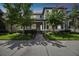Charming two-story home with landscaped yard and a cozy front porch with rocking chairs at 12272 Rangeland Blvd, Odessa, FL 33556